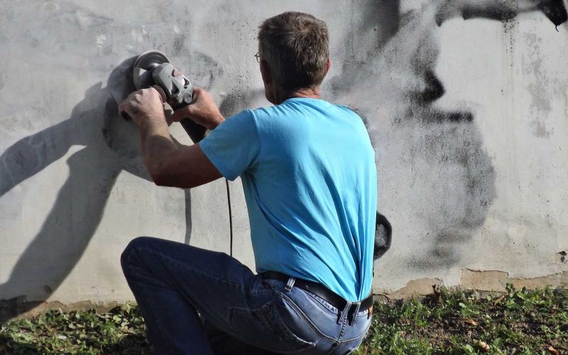 Man removing graffiti
